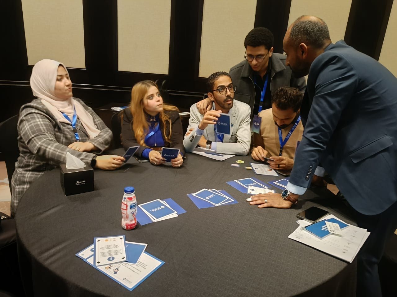 Facilitator working with a team during a card-based simulation